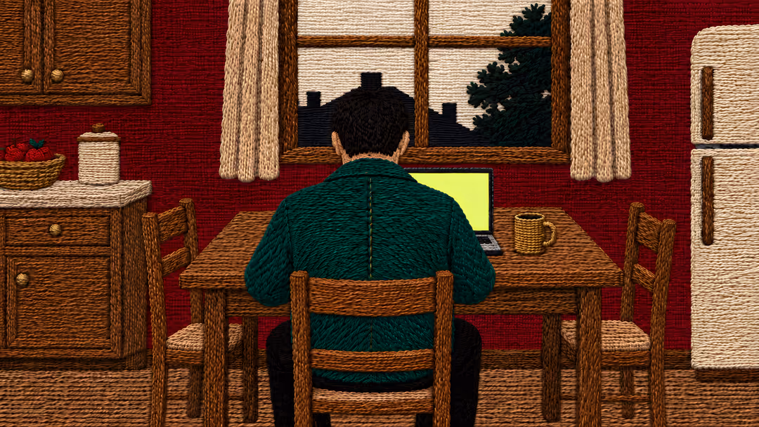 Embroidered illustration: a man in a green jacket, seen from behind, works at an open laptop on a kitchen table; morning light in the window.